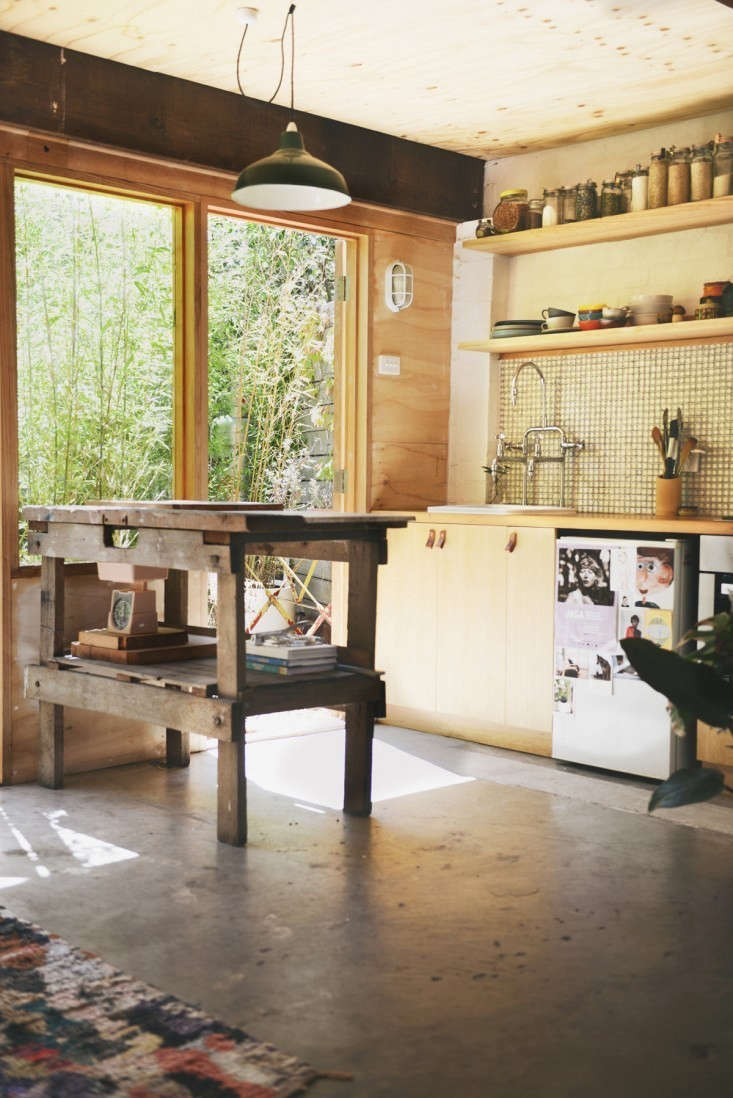Melbourne, Australia-based Hearth Studio turned a garage into a small home complete with kitchen, dining area, bedroom, and bath (with green clawfoot tub). The designers managed to fit it all in while retaining the character of the garage, including its hardworking concrete floor. For more, see Outbuilding of the Week: Garage Turned Studio Apartment. Photograph by Lauren Bamford.
