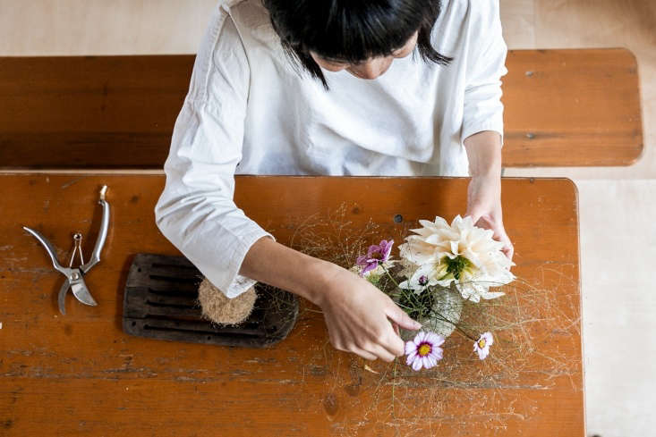 yasuyo arranges dahlias with flowers and fronds from the garden. 13