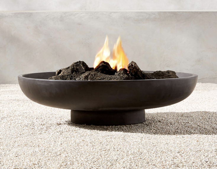 The Form Black Cement Fire Pit measures 38-inches across and is strictly made for wood-burning; currently on sale for \$700 at CB\2.