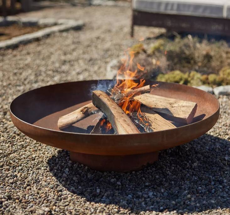 The minimalist Weathering Steel Round Bowl Fire Pit, made of corten steel, is a great value at \$348 at Terrain.