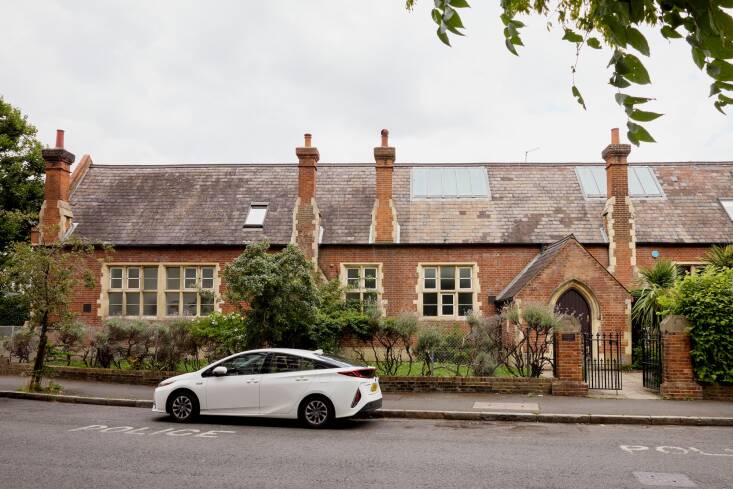 The building is constructed with Portland stone quoins and has a slate roof. 
