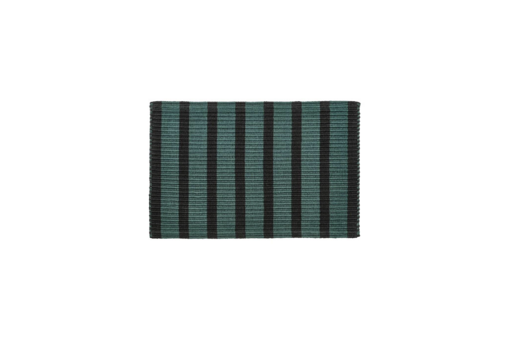 A stylish cotton door mat to lay at the threshold to your outdoor space. It\2\17;s available in green/black (pictured) and pink/orange. Shop now.