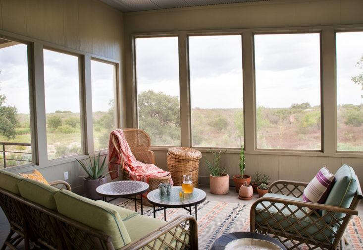  Austin-based interior designer Ann Edgerton designed a screened porch with a soft bohemian look using vintage rattan furniture, Moroccan accents, and bright textiles. “I wanted to create a place you can grow into with new textiles and plants,” she says. Photograph by Molly Winters courtesy of Ann Edgerton, from Steal This Look: A Bohemian Screened Porch in Texas.