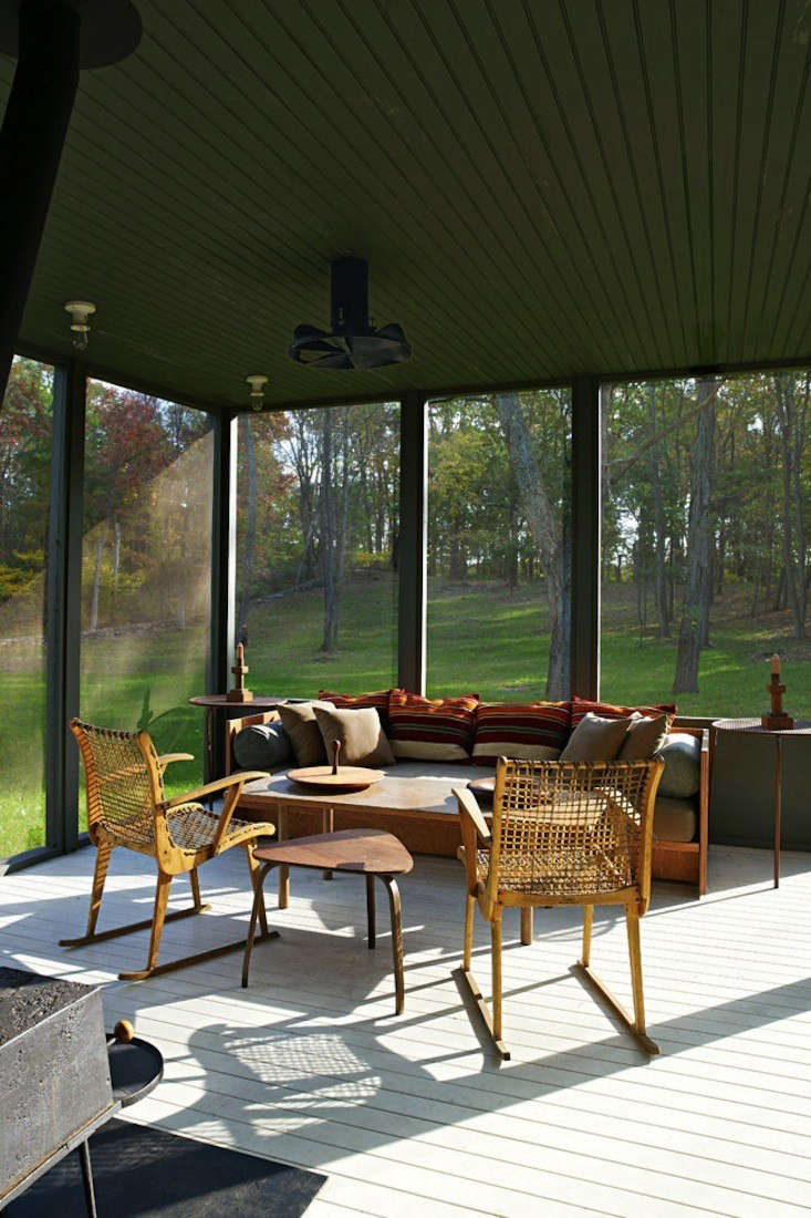  Architects Calvin Tsao and Zack McKown’s screened porch at their weekend place in Rhinebeck, New York has  pleasing blend of green walls (so dark they border on Gothic) and midcentury Danish antiques. Photograph by Richard Powers for Tsao & McKown Architects, from Steal This Look: The Perfect Screened Porch.