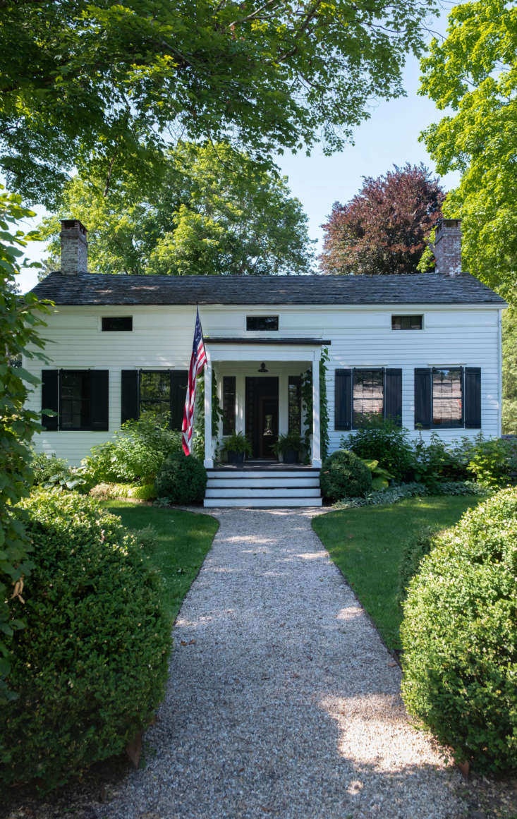 The circa-\1830 house is set back from a main street in Claverack, where tall hedgerows abut the road and conceal the historic houses and sprawling gardens behind.