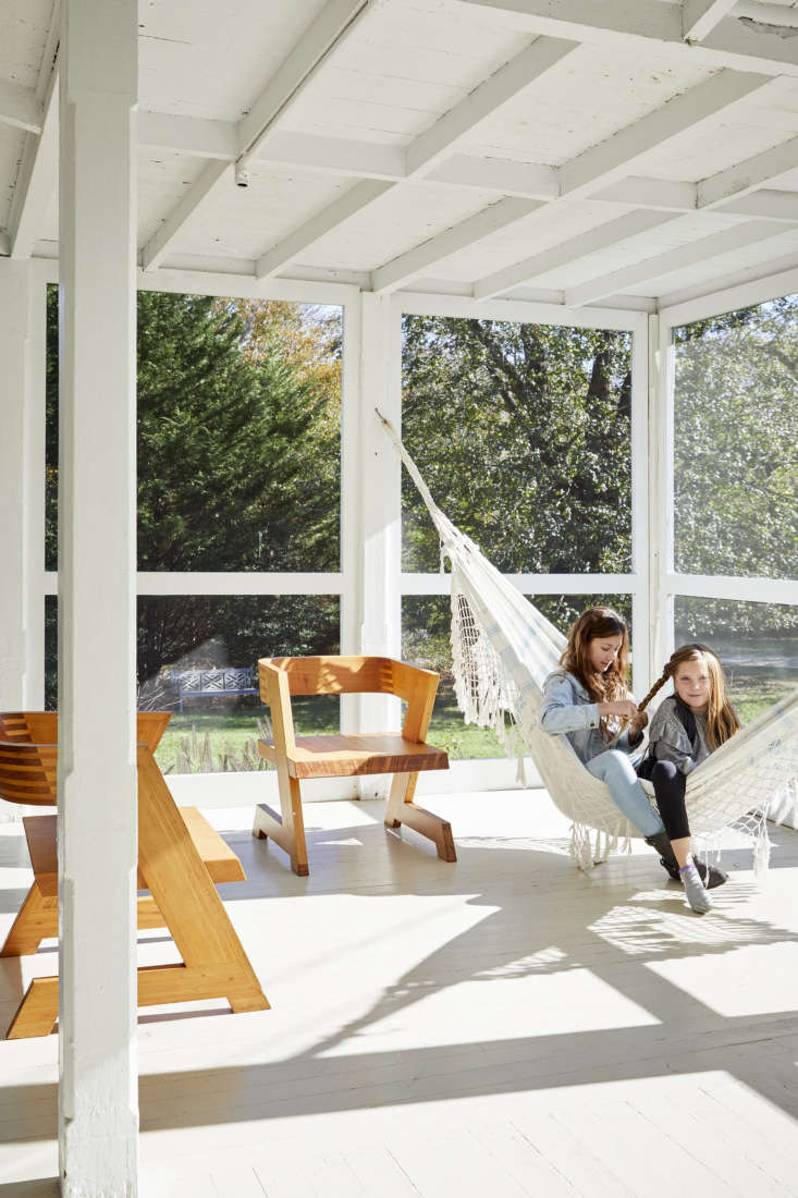 A hammock is the perfect minimalist accessory for this light and bright porch. Photograph by Dana Gallagher, styling by Hilary Robertson, for Farmhouse Refresh: An Antiques Dealer’s Clean and Simple Family Retreat on Shelter Island.