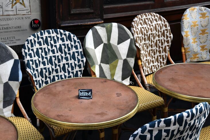 Artist Wayne Pate&#8\2\17;s Paris-inspired fabric on cafe chairs. Photograph courtesy of Studio Four NYC and Wayne Pate, from Inspired by a Year in Paris: Wayne Pate’s New Fabric and Wallpaper Collection from Studio Four NYC.
