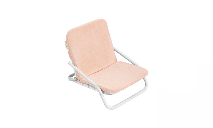 The Cushioned Beach Chair by outdoor co. Sunnylife is designed for comfort, with a removable padded terrycloth cushion; it&#8\2\17;s \$\1\20 from Revolve.