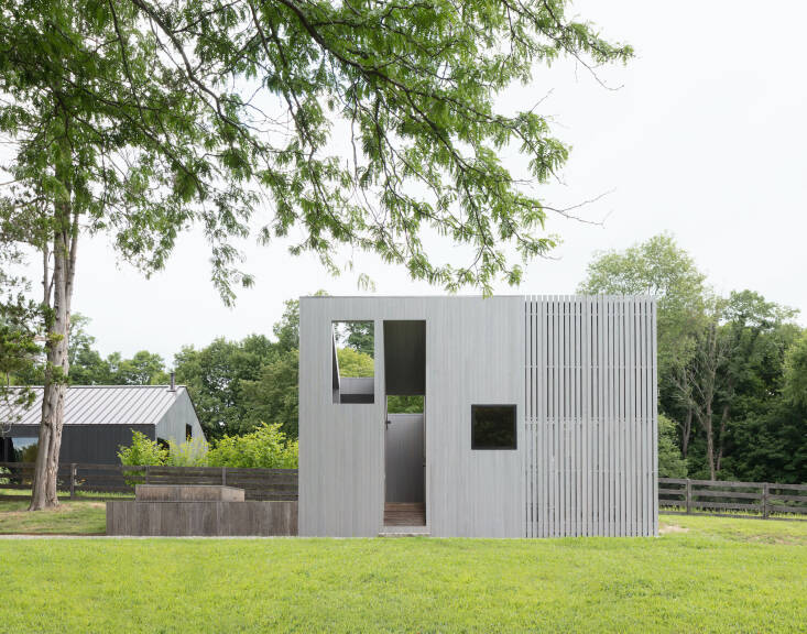 The spa shed is clad in weathered gray cypress. The architects made a point of choosing a shade that was lighter than the other two buildings.