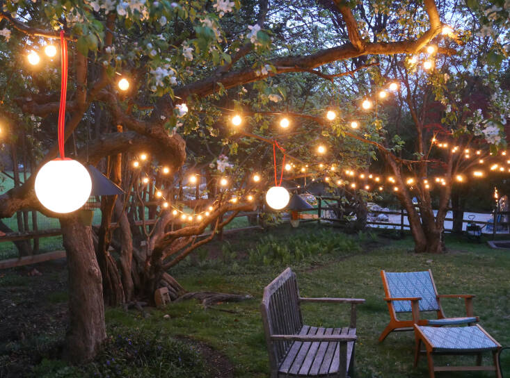 Our backyard, lit up with rechargeable hanging globe lights by FatBoy and new string lights by Brightown. Photograph by Sally Kohn.