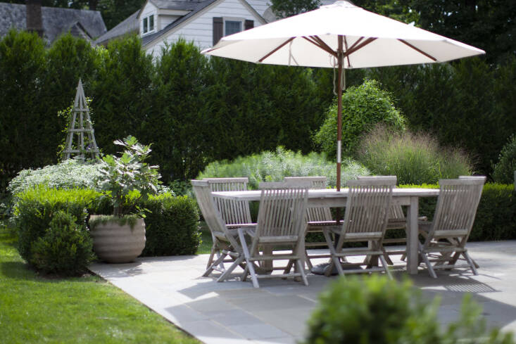 The hard lines created by the bluestone patio add order and formality to the garden design.