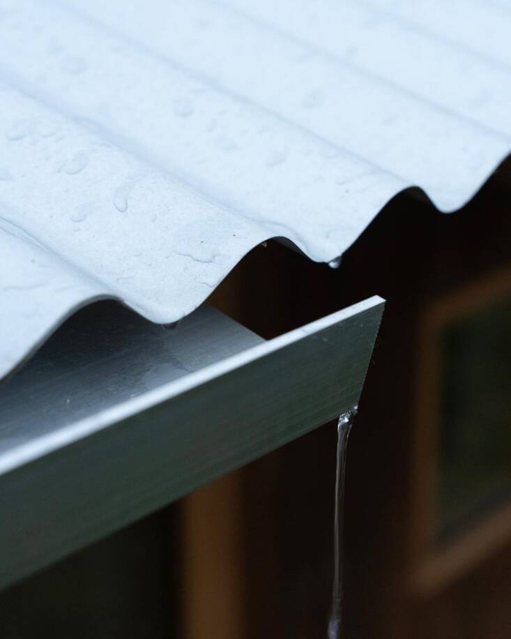 A corrugated Aluzinc roof paired with a simple L-profile aluminum trough.