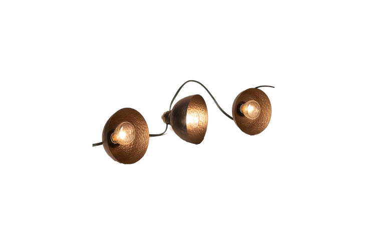 The string lights are custom by sculptor Rico Duenas and made with brass cups that patina over time. Contact Rico Duenas for commissions and more information. For an easy alternative, though certainly not as artful, the LumaBase Electric Cafe String Lights with metal domes is \$45 at Amazon.
