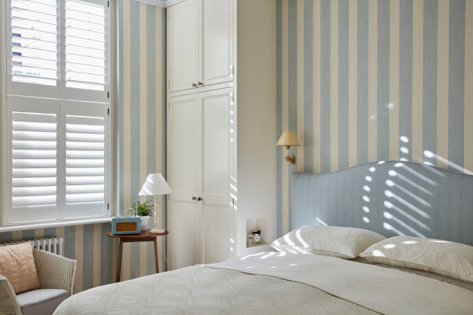 Bedroom with striped wallpaper