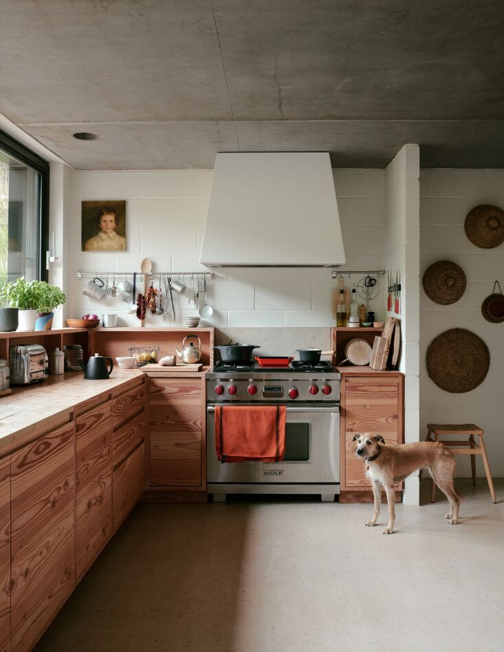 Cabinets, treated simply with a coat of white oil stain, highlight the beauty of Dinesen Douglas fir. Photograph by Michael Reynolds, from “Beauty Found in Simplicity”: At Home in Devon with Design Purists Russell and Oona of Pinch Furniture.