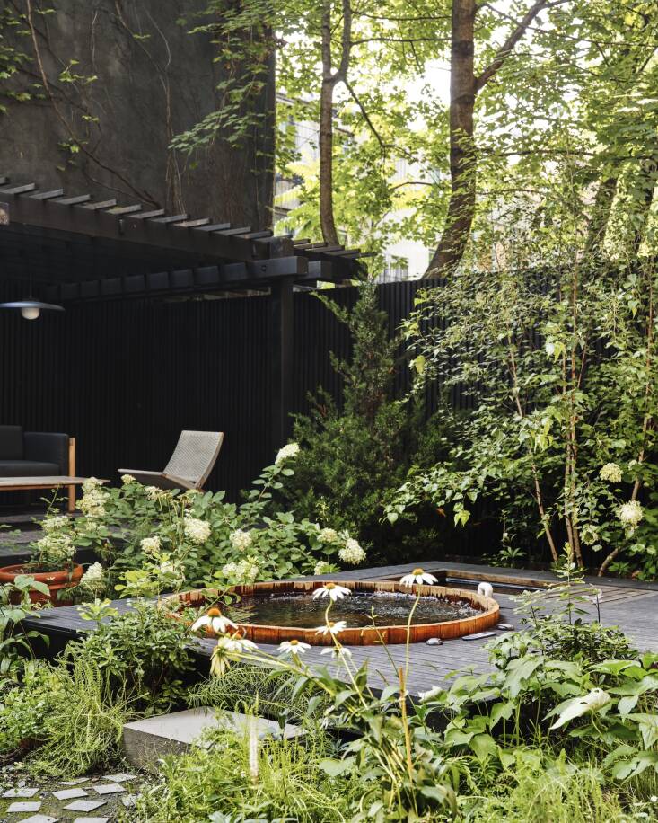 \2\20;The pergola itself is landmarked because the top of the structure is visible from the adjacent street, so for many reasons, we kept it! Neither the pergola nor the deck were in the best condition, so the restoration required significant repairs and refinishing, including replacement of all of the \2&#\2\15;\2 purlins on top. The pergola was made of cedar and the existing deck was made of solid 4&#\2\15;4 pine members. It was impossible to know the original finish of the pergola or deck under probably decades of aging, but after sanding every member, we refinished it with black pine tar to match the new interior fence and pool deck.\2\2\1;