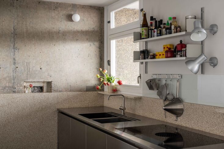 A simple galley kitchen with exposed concrete wall. Photograph by French+Tye, from A Brutalist Remodel: Honest Materials and Bespoke Upgrades in a Trellick Tower Apartment.
