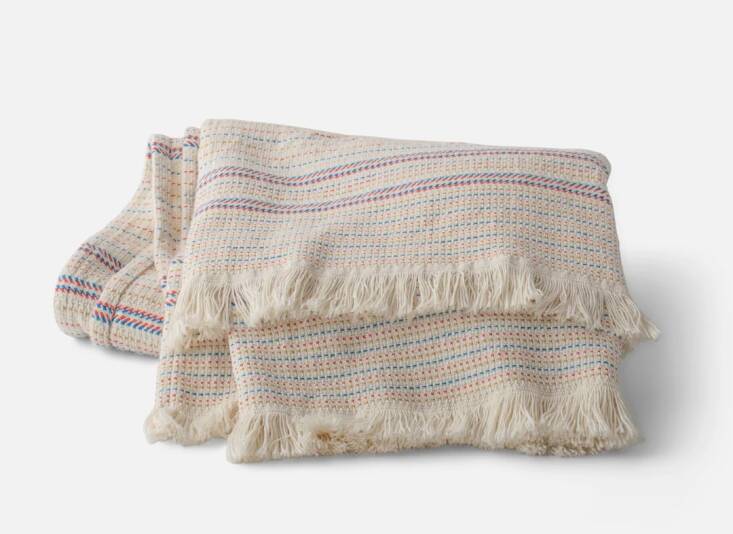 The makings of an ideal picnic blanket: machine-washable, OEKO-TEX certified cotton in summery stripes. Shop now.