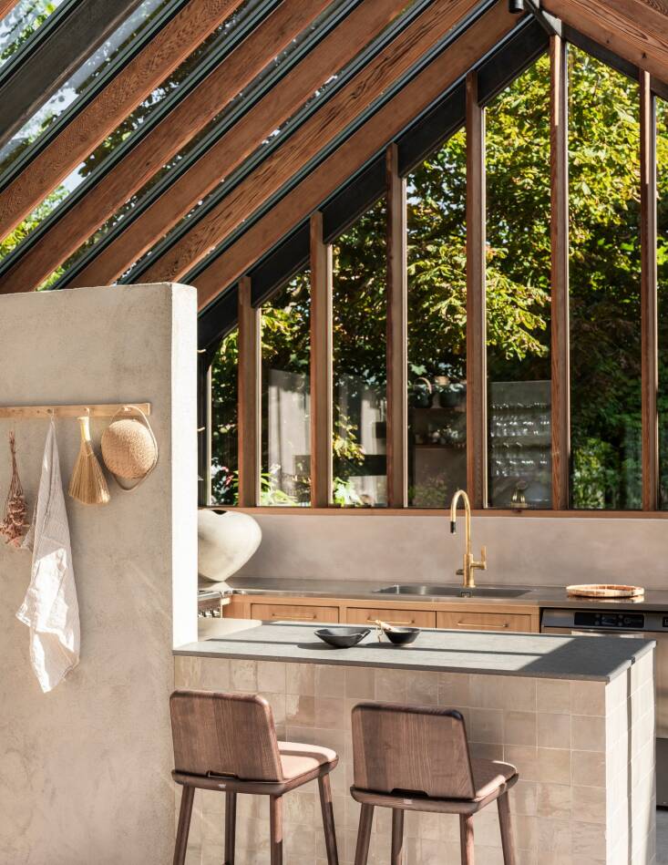 The peninsula abuts a half wall that separates the cook space from the rest of the room.