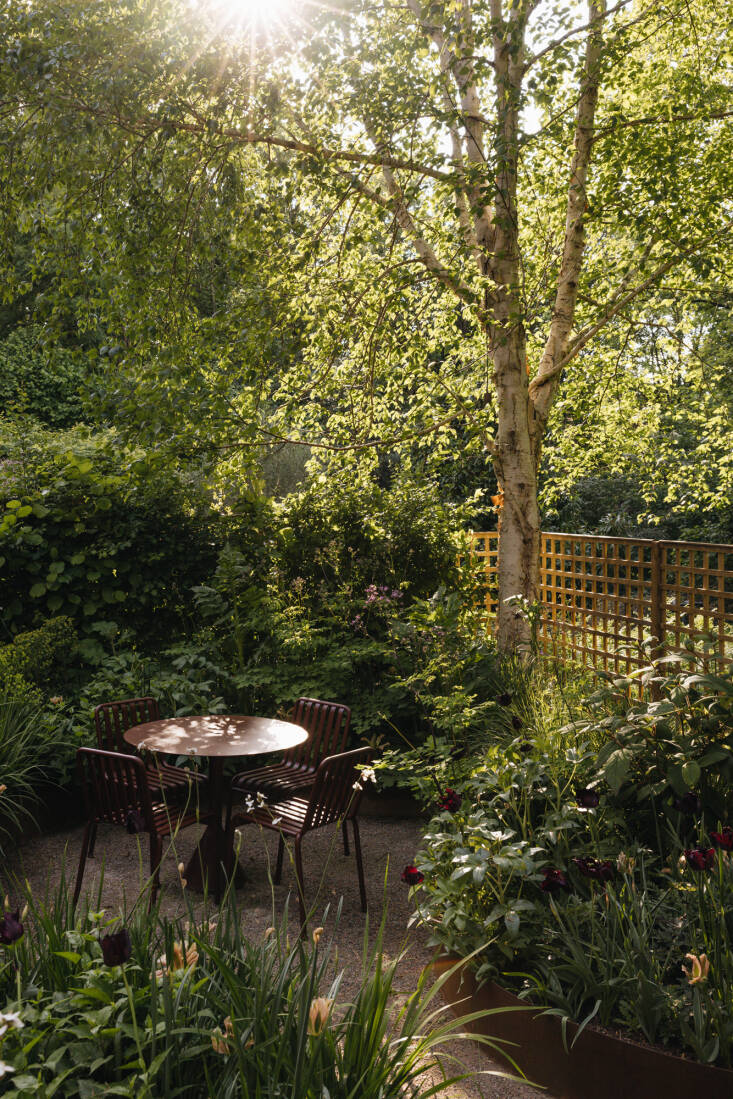 Alexandra relied on Hay for all the outdoor furniture. The cafe table and chairs, in Rust Red, are from Hay\2\17;s Pallisade Collection—as are the lounge chairs on the deck and the bench next to the stairs.
