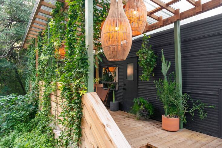  Above: In Austin, Texas, Barton Springs Nursery co-owners Amy Hovis and Greg Thomas spent a year living in a \1990s trailer on their nursery property. Painting the \249 square-foot trailer black and adding a deck helped to make the plants take centerstage. Hovis and Thomas have a forthcoming book, A Home Called Outside: How Living Small Opened Our World, about the experience. Photograph by Greg Thomas.