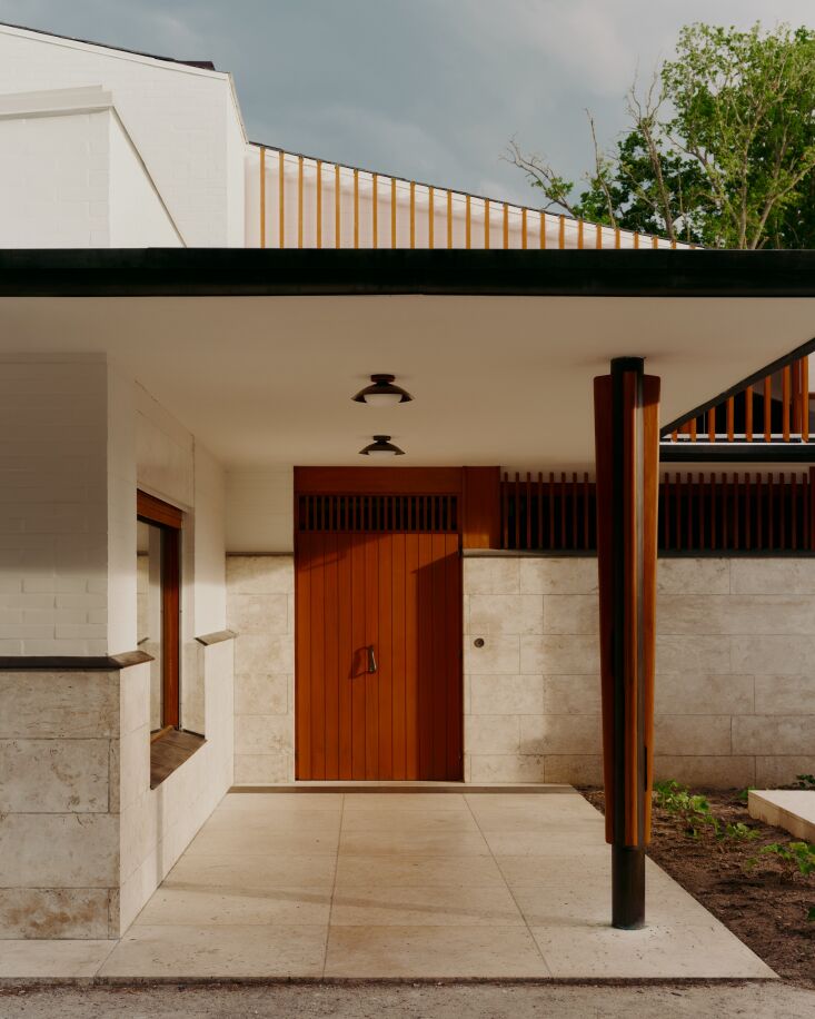 An Alvar Aalto building doesn\2\17;t need much embellishment, but this front door in a rust-orange hue certainly enhances its curb appeal. (Leading up to the door are two Arundel Mushroom Surface Mount lights by In Common With.) Photograph by Bastian Achard, from Maison Louis Carré: Aalto’s Architecture, Revisited by In Common With.
