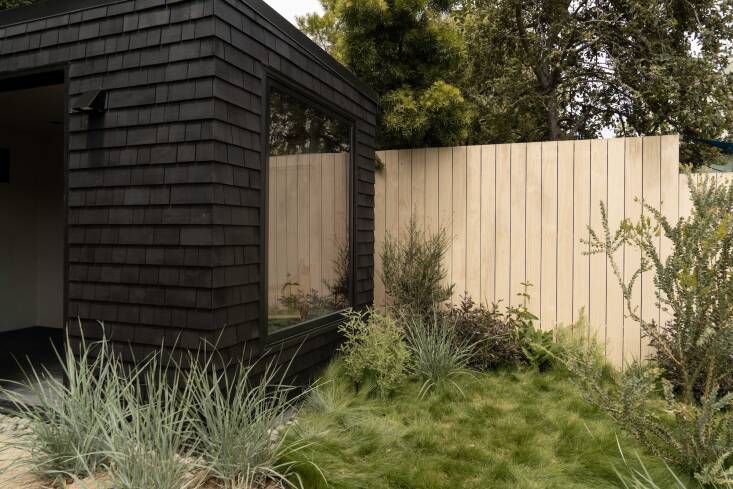 For a recent project, ORCA paired a newly-built black house with a natural wood fence. \2\20;We like the natural wood as a contrast to the black,” explains Sedlacek. “It creates layering and depth so the landscape doesn\2\17;t blend into the architecture.” Photograph by Cass Cleave for ORCA.