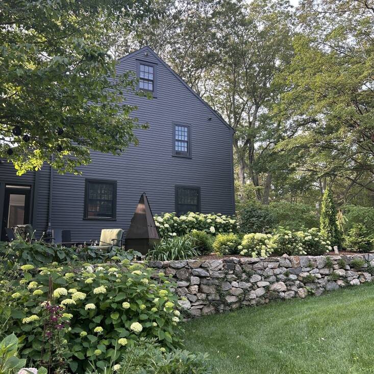 Food stylist and cookbook author Suzanne Lenzer, who moonlights as a woodworker and an avid gardener, painted her Connecticut home black, and it\2\17;s become a high-contrast canvas for the profusion of Annabelle hydrangeas planted around the house. Lenzer started with just black siding and then painted the trim black too for a uniform look. Photograph by Suzanne Lenzer.