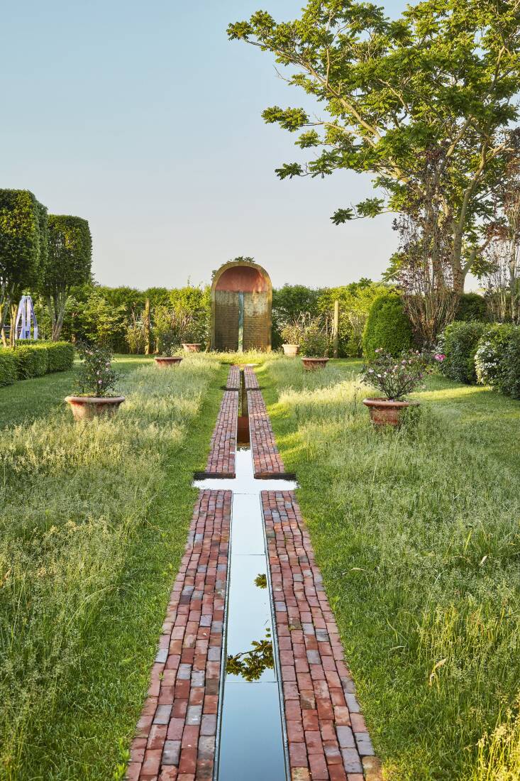 The Rill was originally a brick path built to draw the eye out to the farm fields beyond. As the surrounding area began to fill in with newly built houses, Dash added the water element and the brick exedra at the end. After the small bulb meadow blooms in spring, the lawn is left unmown for a few weeks to let the bulb foliage mature.